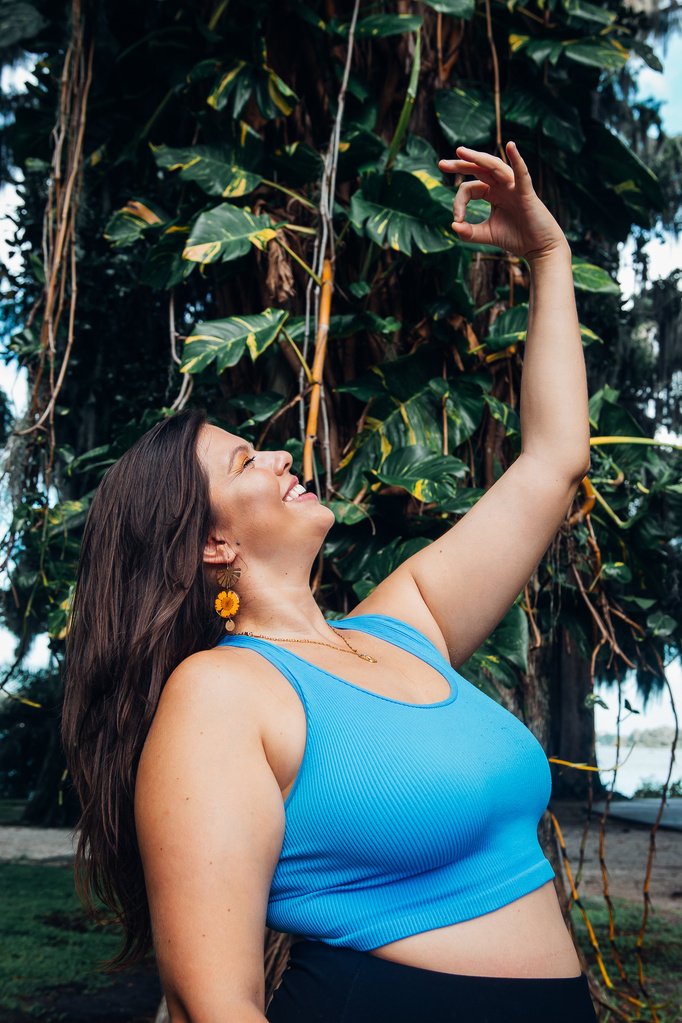 Mandy reaching toward sunlight through vines, therapist for Fort Myers